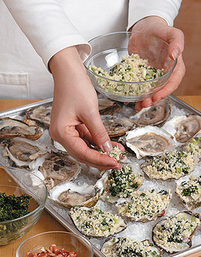 To ensure the Oysters Rockefeller stay upright during baking, nestle them into a thick bed of kosher or rock salt.