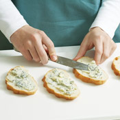 Spread the blue cheese butter generously over four slices of bread, then top with a tomato slice.