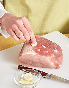 Cut small slits into the pork with a paring knife, then insert garlic slices into them to ensure flavorful meat. 