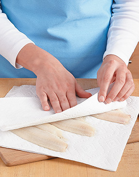 To help the salt, pepper, and flour adhere, be sure to blot the fillets dry with paper towels.
