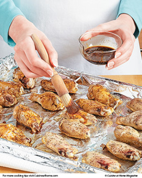 Ensure even cooking without burning the glaze by broiling the wings before basting them.