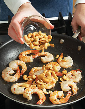 Cashews take the place of traditional peanuts in this soup. Stir-fry them with shrimp to toast lightly.