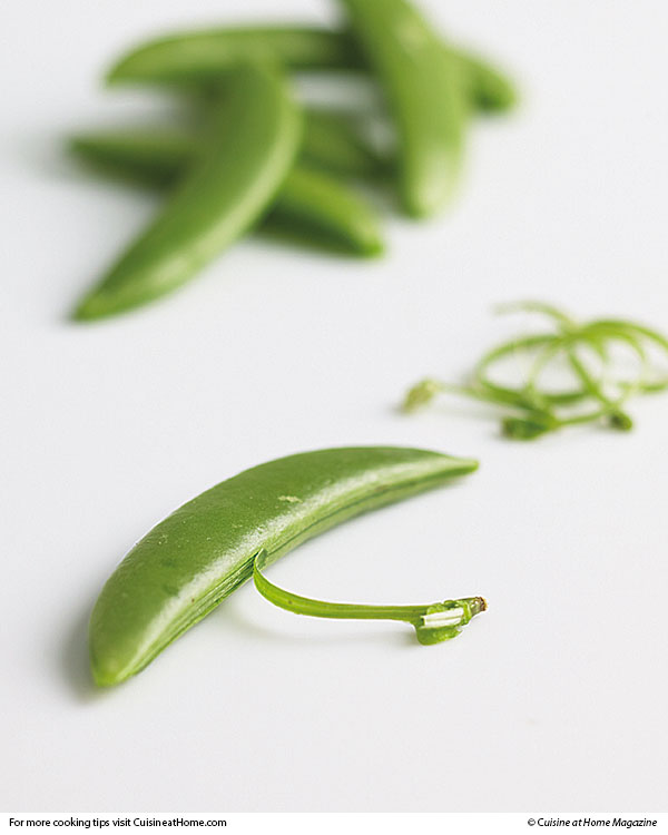 Stringing sugar snap peas makes them less chewy. Just snap the tip with your fingers and give the tab a pull like a zipper.