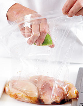 Squeeze lime into a plastic bag with chicken, oil, and salt. Seal bag and turn chicken pieces to coat.