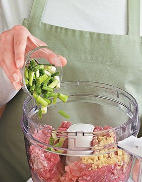To enhance the flavor of the pork, use a food processor to mix in ginger and scallions.