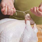 Overlap the ends of the legs, then tie them together at the knuckles using butcher&rsquo;s twine.