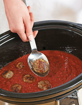 Simmer the meatballs in the sauce to add flavor to the sauce and finish cooking the meatballs.