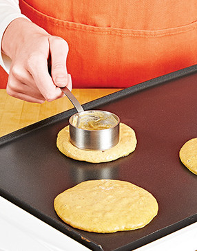To be sure the pancakes cook all the way through, gently spread the thick batter out on the griddle.