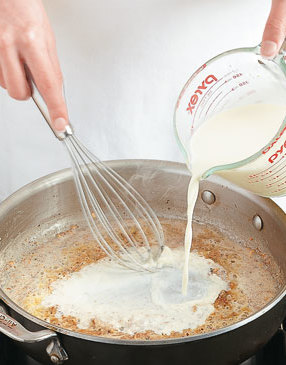 The roux in the pan thickens the milk for the sauce, but whisk the milk in slowly to prevent lumps.