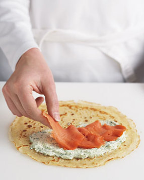 Spread 2 Tbsp. cheese filling over one half of each crêpe. An offset spatula works well for doing this. Top crêpe with salmon.