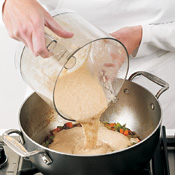 Purée some of the beans and broth until smooth, then add the mixture to the pot to create the soup base.