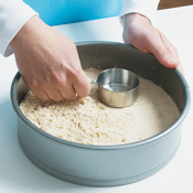 Pat the dough down with a measuring cup until evenly flat.