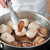 Sear scallops about 1 minute on each side. Scallops are done when they feel firm to the touch.