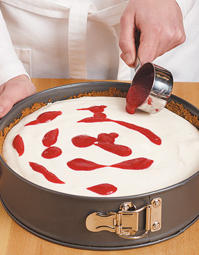 Drizzle the raspberry sauce randomly around the top of the pie for easier swirling and marbling.