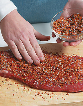 Rub both sides of the flank with the spice mixture, pressing into the meat so it adheres.