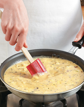 Stir mixture to distribute fillings. Once the eggs thicken and begin to set, transfer the frittata to the oven.