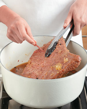 The corned beef is done braising when you can easily pull a strand of the beef with your fingers.