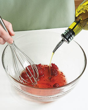 Combine vinaigrette ingredients, lightly crushing raspberries with a whisk while adding the oil. 