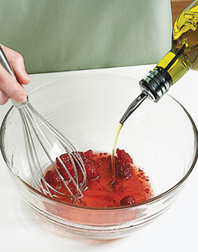 Combine vinaigrette ingredients, lightly crushing raspberries with a whisk while adding the oil. 