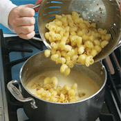 Stir cooked pasta into sauce. It may seem soupy, but the macaroni will absorb some of the moisture during baking.