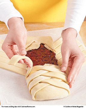 Braid dough strips over the filling by alternating strips from each side. It's OK if some of the fruit leaks out.