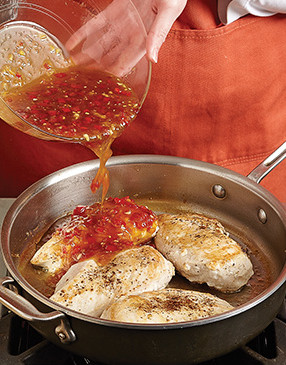 Adding the sauce to the pan with the chicken and simmering allows the cornstarch to thicken the sauce.