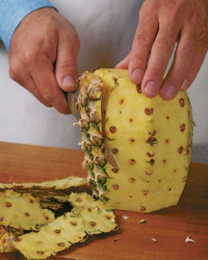 Pineapple is one of the more difficult fruits to cut, because it's large, has a spiky skin and those prickly "eyes" inside the fruit once you've cut it. Here’s a way to peel pineapple with as little waste as possible and get the bonus of decorative slices