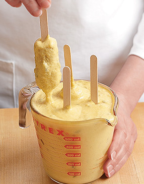 A tall measuring cup allows you to easily coat each hot dog in batter. It's the perfect vessel for dunking.