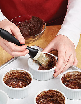 For easy unmolding and added flavor, generously coat the molds with the butter-cocoa mixture.