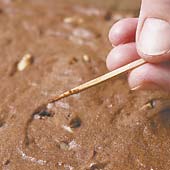 Bake brownies until a toothpick comes out with moist crumbs adhering to it. Cool brownies before cutting.