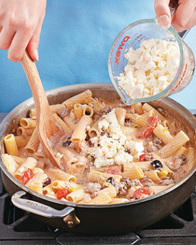 Stir half the feta into the sauce. As it softens and sets, it acts as a binder to hold the mixture together.