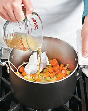 Deglaze the pot with cider vinegar. Acidity provides the tangy flavor that sauerkraut gives the sandwich.