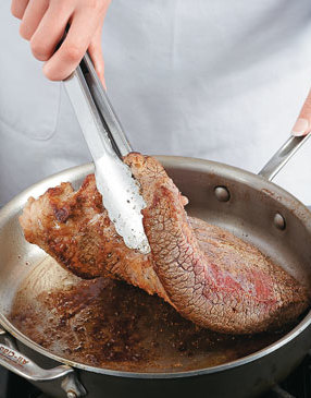 Sear brisket in a sauté pan in hot oil until browned on both sides. This step adds flavor to the brisket.
