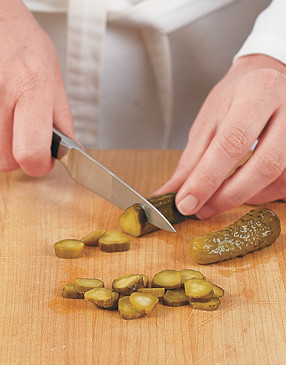 Tiny dill gherkins are the perfectly sized pickle for slicing to garnish these small sandwiches.