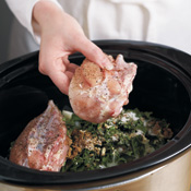 Placing the chicken breasts on top of other ingredients in the slow cooker keeps the chicken moist.