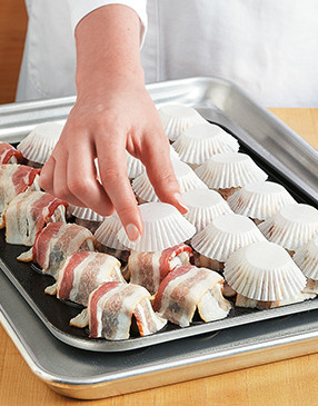 The liners help form the bacon into cups and keep the bacon from sticking to the top baking sheet.
