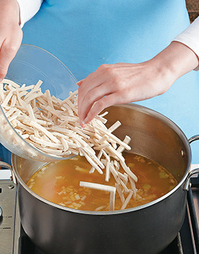 To create velvety texture, use frozen egg noodles &mdash; they're coated in flour and help to thicken the broth.