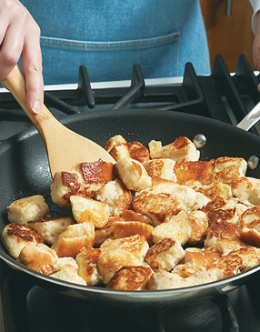 Saut&eacute; half the soaked bread cubes at a time in oil. Add butter once they're golden.