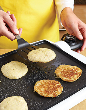 Once the bubbles begin to break on the pancake tops and their bottoms are browned, flip them.