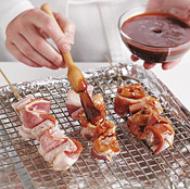 Coat the skewers with sauce on all sides before roasting, then turn and baste periodically for even cooking.