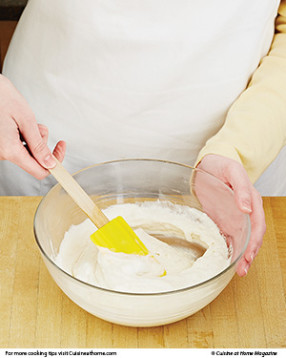 Stir in some egg whites to lighten the batter, then fold in the rest in batches so as not to deflate them too much.