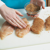 Rub both sides of the chicken with the spices, pressing them onto the meat so they adhere well.