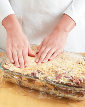 Press down on the strata to encourage the bread to absorb the egg-milk mixture.
