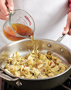 Pour the sherry over the artichokes and olives and simmer to reduce it, deepening and infusing its flavor.