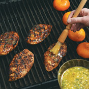 Grill the chicken and oranges, basting the chicken often with the mojo sauce.