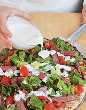 To prevent the lettuce from getting soggy, drizzle the dressing on the pizza right before serving.