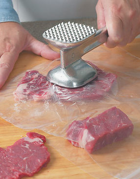 To flatten the steaks easily and avoid splatter, place the meat between pieces of plastic wrap before pounding.