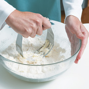 Use a pastry blender to cut butter into the flour mixture until butter pieces are the size of peas. 