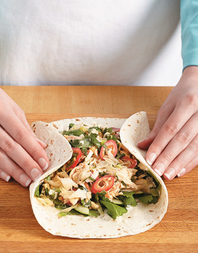 Fold in the sides of the tortillas to cover filling, then roll them from the bottom up like a burrito.