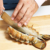 To split lobster tails, start from the fin and slice through meat and shell, pressing firmly.